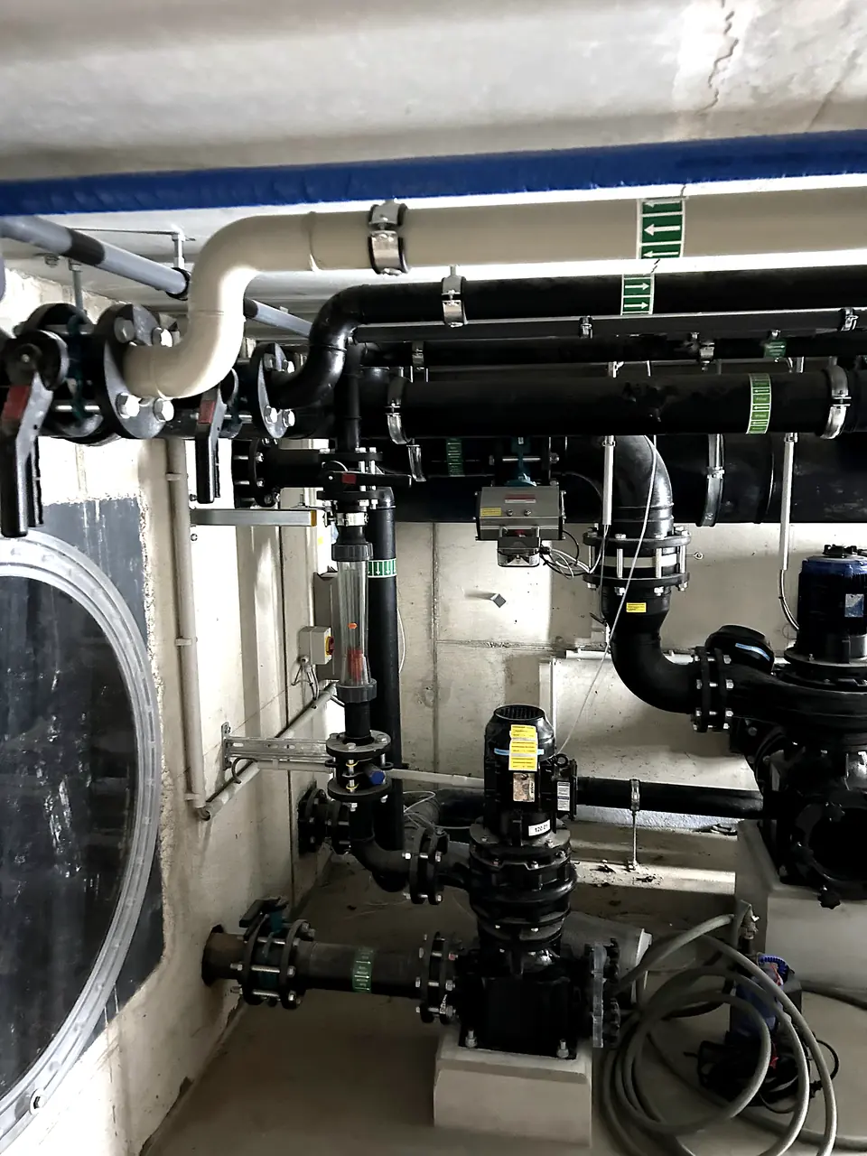 Pump piping next to a tank