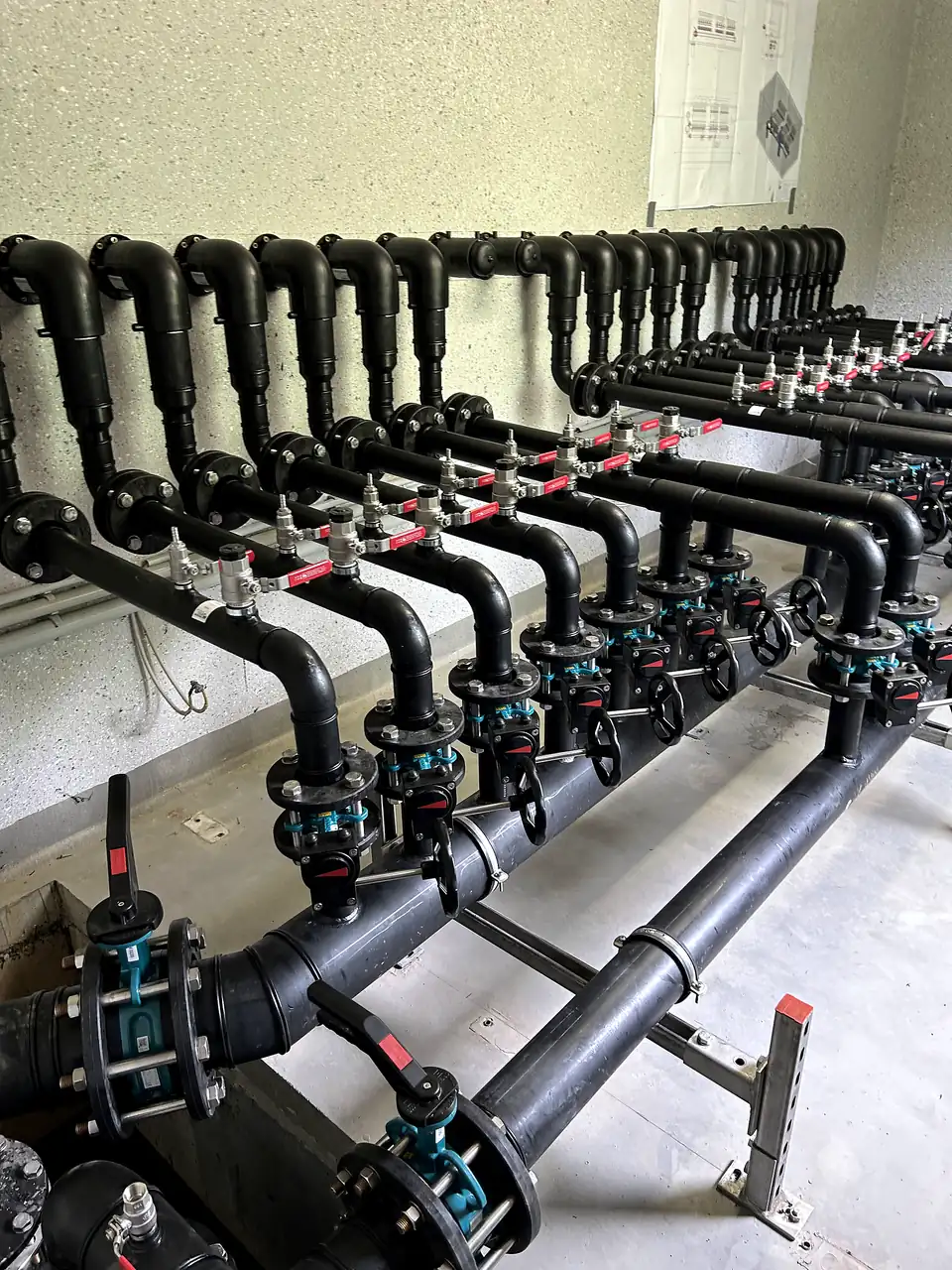 PE pipe manifold with valves in a plant room