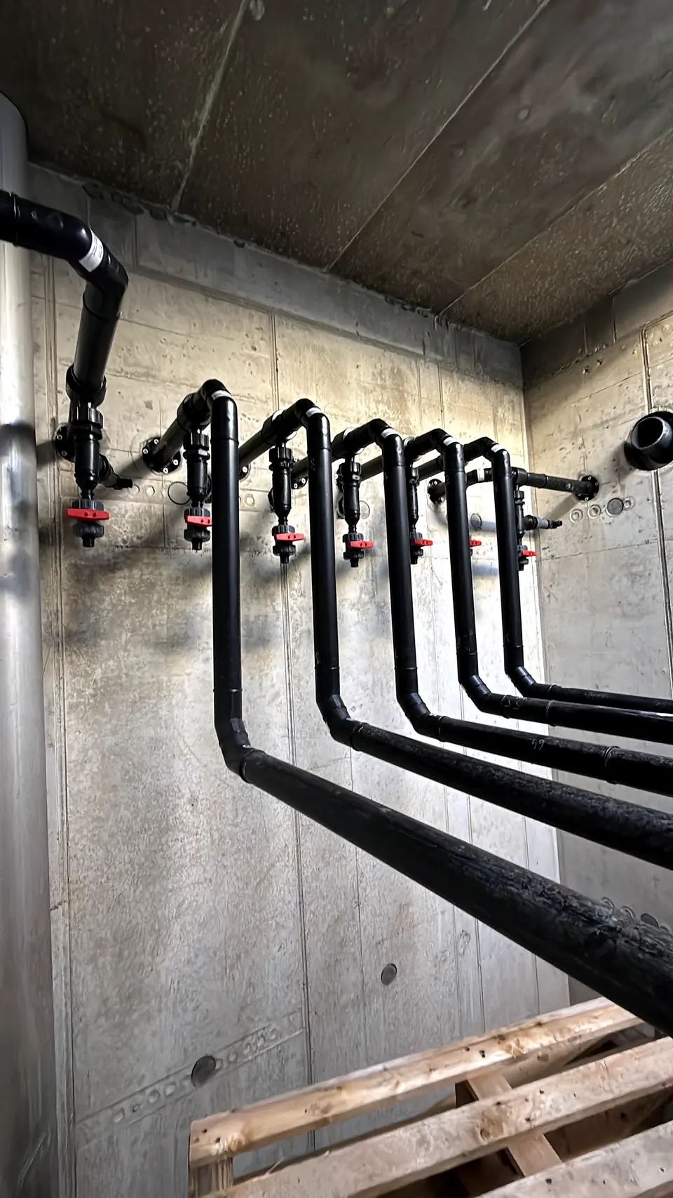PE pipes routed along a concrete wall