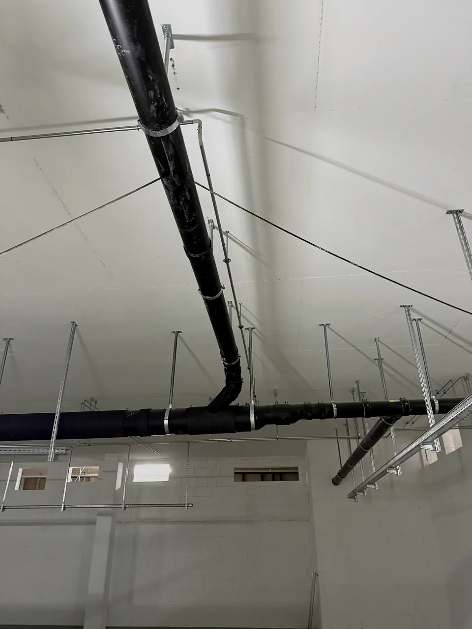 PE pipeline on hangers below the ceiling