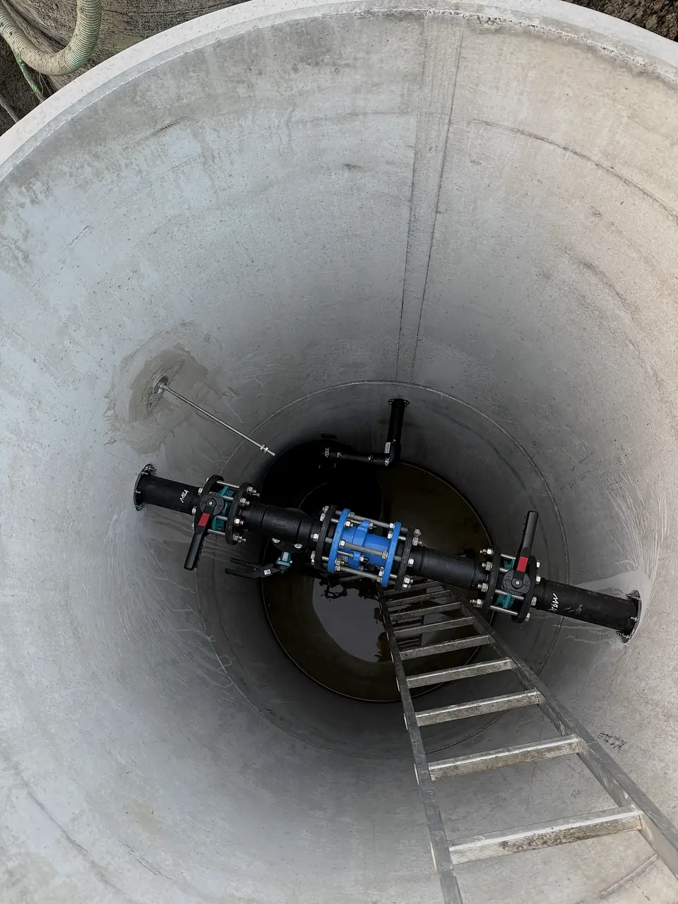 PE pipeline in a concrete manhole